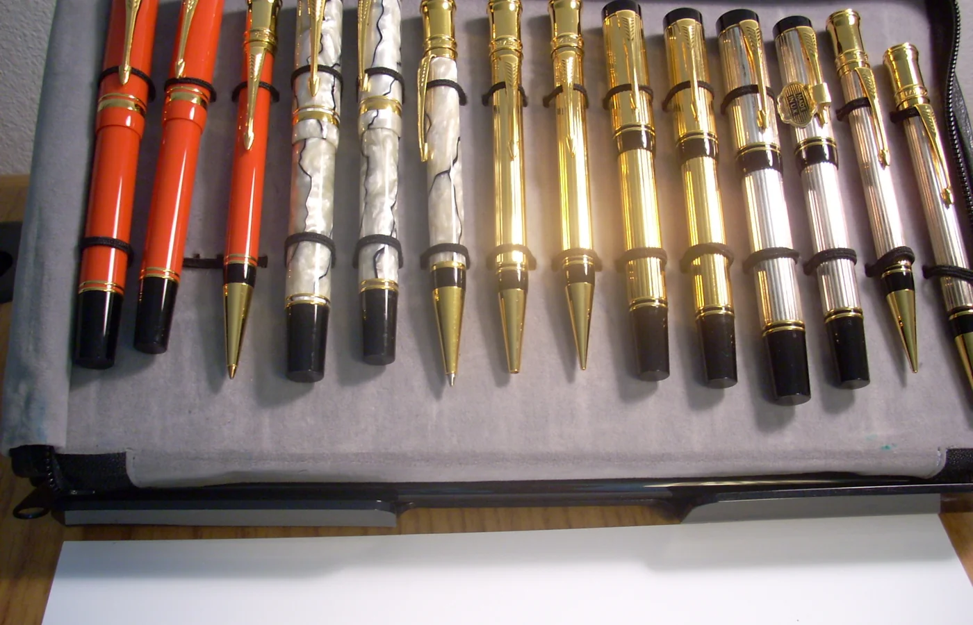Collection tray filled with fine writing instruments in red, pearl, gold and silver finishes